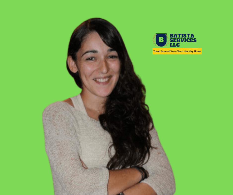 Woman smiling in front of a green background with Batista Services LLC logo and slogan.